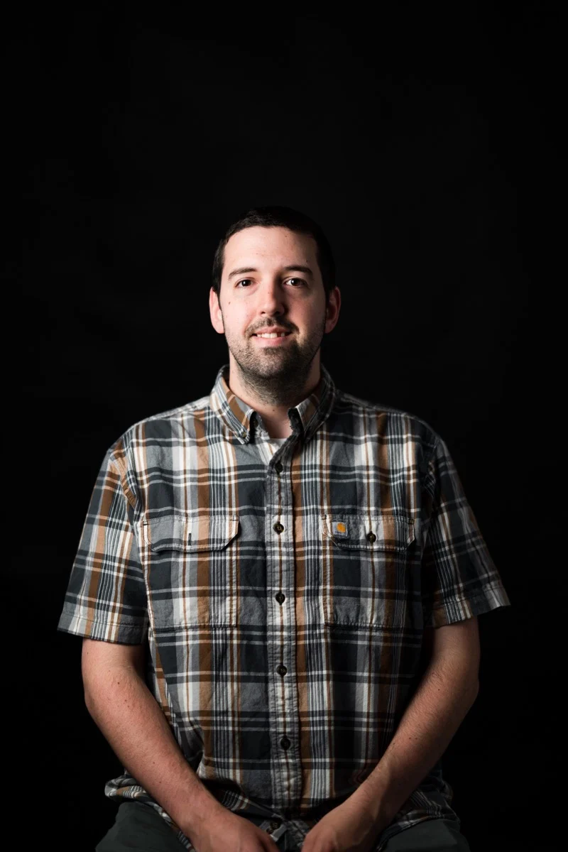 Eric Hammett seated against a dark background